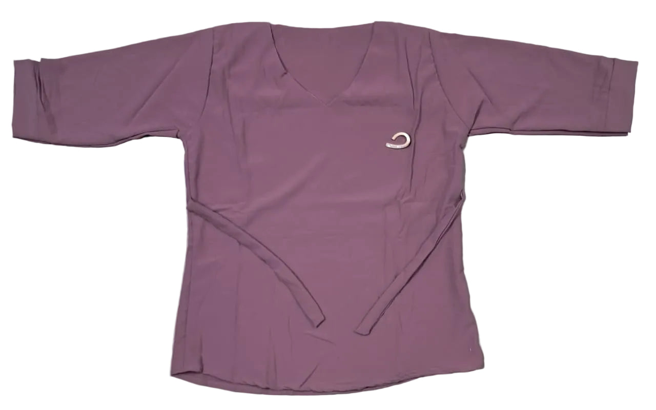 Purple long-sleeve top with a logo on a light-colored floor